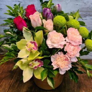 Modern and lush filled with tulips orchids roses carnations and crisp foliage