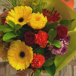 A vibrant bouquet of mix of fresh seasonal flowers - Roses, carnations, gerberas and chrysanthemums.