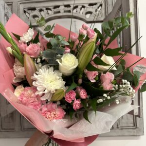 Pink bouquet called Celebrate Mum. Including lilies, roses and carnations.