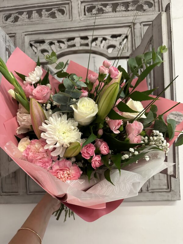 Pink bouquet called Celebrate Mum. Including lilies, roses and carnations.
